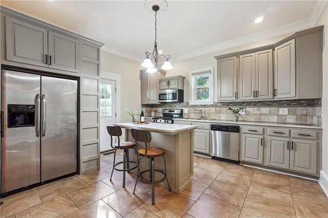 kitchen featuring gray cabinets, light countertops, backsplash, appliances with stainless steel finishes, and a healthy amount of sunlight