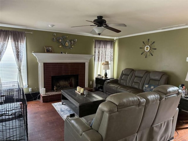 living room with dark hardwood / wood-style flooring, a brick fireplace, ornamental molding, and ceiling fan