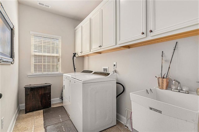 clothes washing area featuring cabinets, washer and dryer, light tile patterned floors, and sink