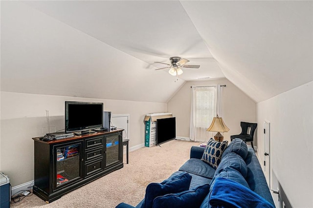 living room with vaulted ceiling, light colored carpet, and ceiling fan