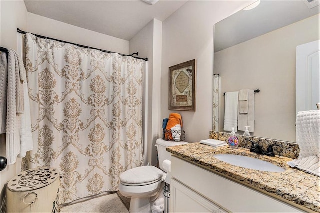 bathroom with toilet and vanity