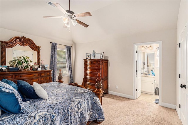 bedroom with light carpet, ceiling fan, vaulted ceiling, and connected bathroom