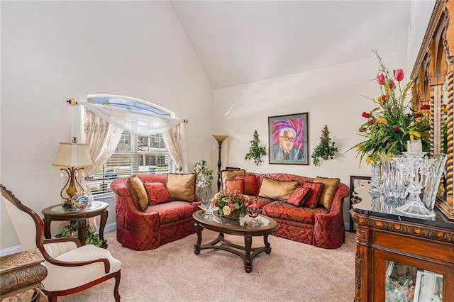 carpeted living room featuring high vaulted ceiling