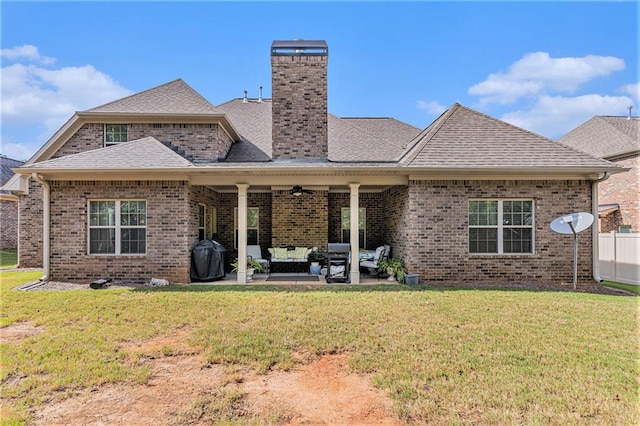 rear view of house with an outdoor hangout area, a yard, a patio, and ceiling fan