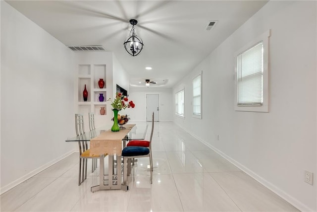 tiled dining area with an inviting chandelier