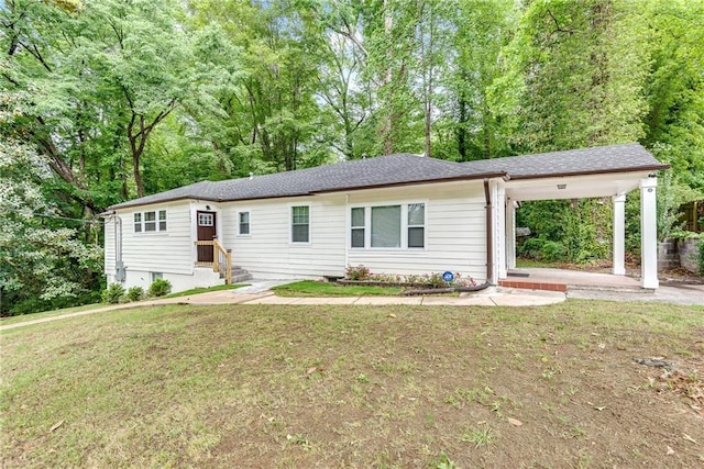 ranch-style home with a carport and a front lawn