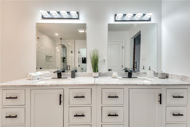 bathroom with vanity and a shower with door