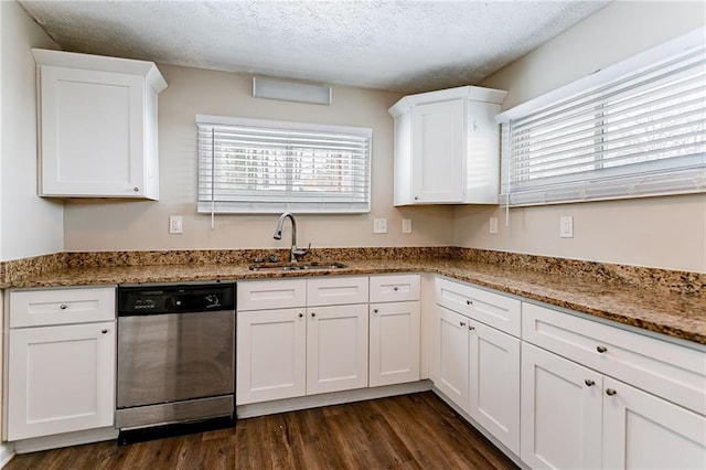 kitchen featuring sink, white cabinetry, stainless steel dishwasher, and a textured ceiling