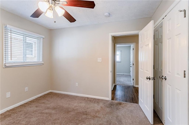 carpeted empty room with a textured ceiling and ceiling fan