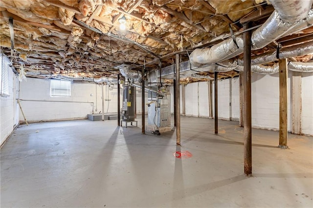 basement featuring heating unit and water heater