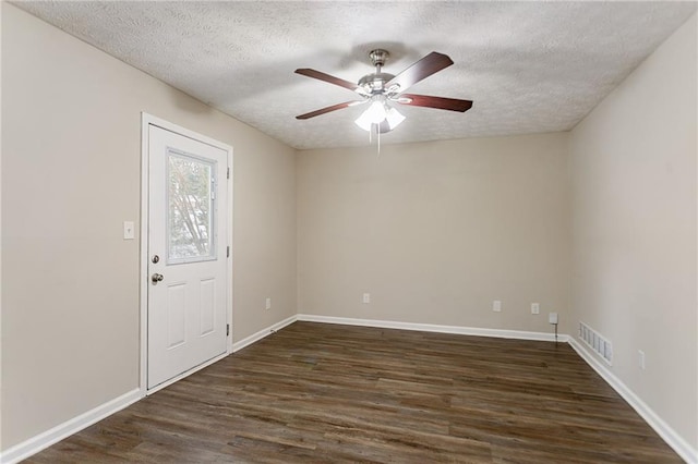 unfurnished room with a textured ceiling, dark hardwood / wood-style floors, and ceiling fan