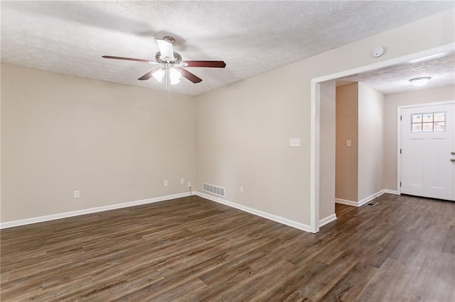 unfurnished room featuring a textured ceiling, ceiling fan, and dark hardwood / wood-style flooring