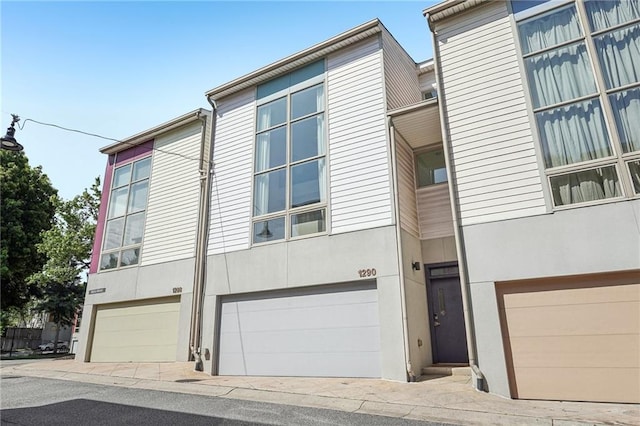1290 Nervi Mews NW, Atlanta, GA 30318 - multi unit property featuring stucco siding and an attached garage