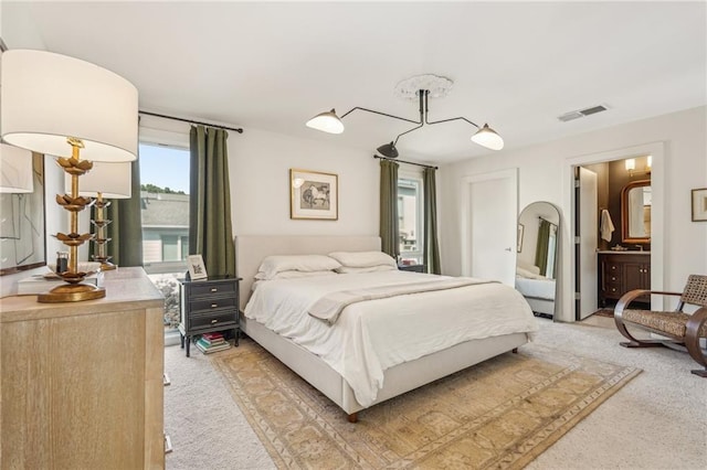 1290 Nervi Mews NW, Atlanta, GA 30318 - bedroom featuring light colored carpet and ensuite bath