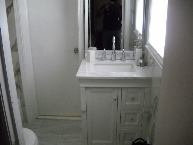 bathroom featuring vanity and toilet