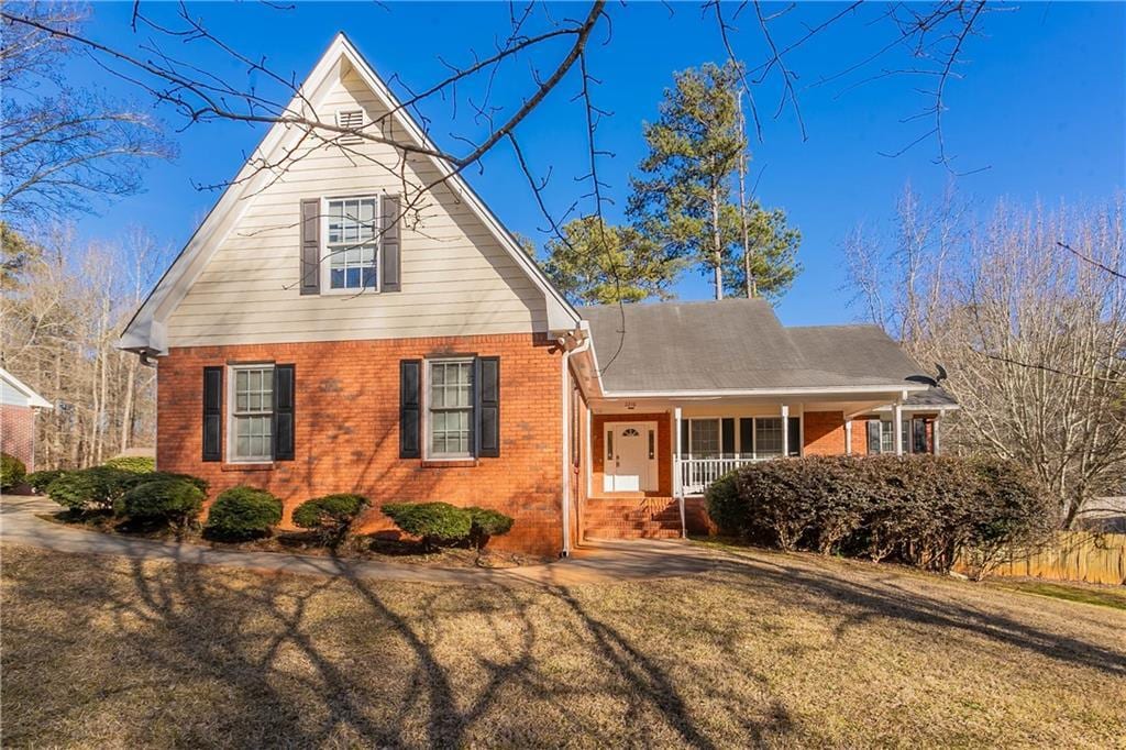 view of front of property with a front yard and a porch