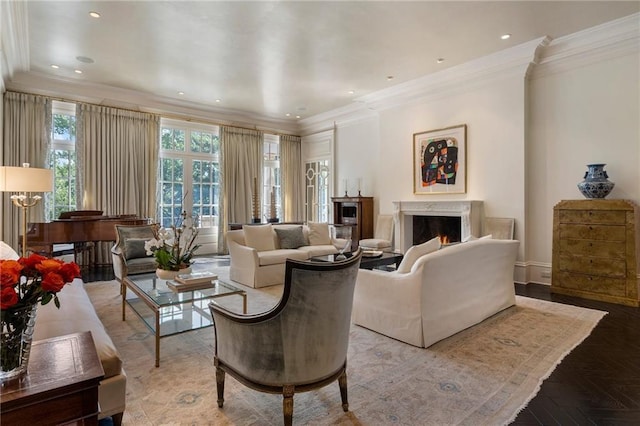 living room featuring ornamental molding, recessed lighting, and a lit fireplace