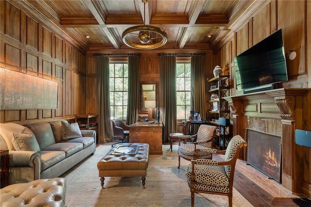 living area with coffered ceiling, wood ceiling, wood walls, and ornamental molding