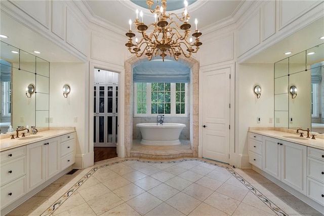 full bathroom with two vanities, a sink, crown molding, baseboards, and a soaking tub