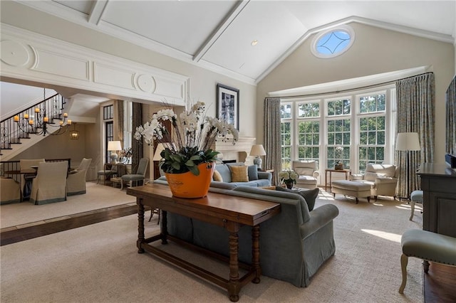 living room featuring stairway, a fireplace, and high vaulted ceiling