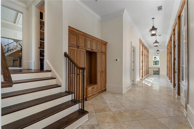 interior space featuring built in features, crown molding, and tile patterned floors