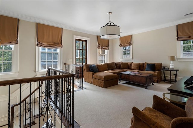 carpeted living area with visible vents and crown molding