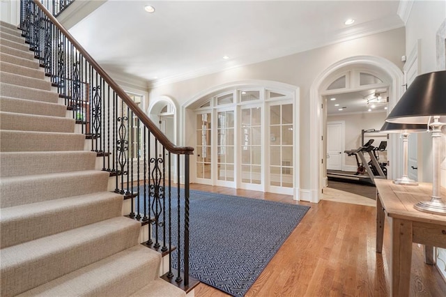 entryway featuring crown molding, recessed lighting, wood finished floors, and baseboards