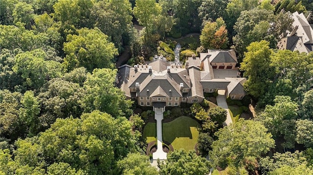 drone / aerial view featuring a residential view and a view of trees