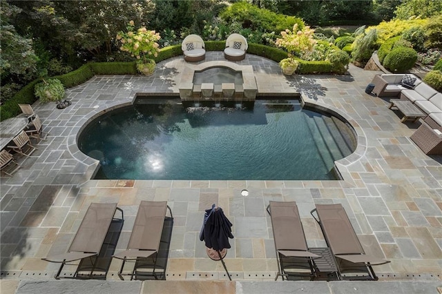 outdoor pool with a patio and an in ground hot tub