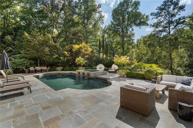 view of swimming pool with a patio area, a pool with connected hot tub, and outdoor lounge area