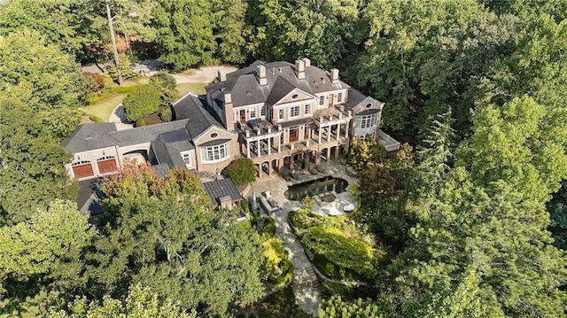 birds eye view of property featuring a view of trees