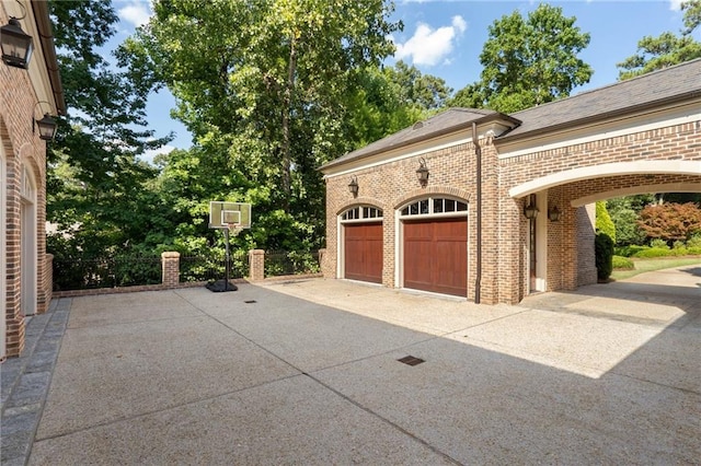 garage featuring concrete driveway