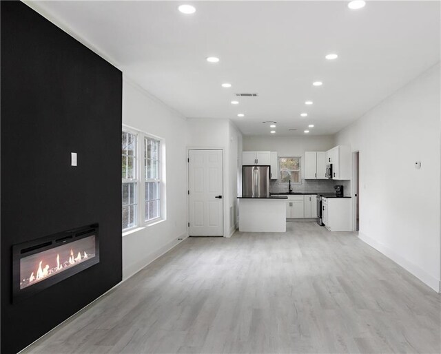 1097 Hubbard St SW, Atlanta, GA 30310 - unfurnished living room featuring a large fireplace and light hardwood / wood-style floors