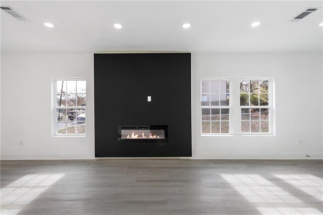 1097 Hubbard St SW, Atlanta, GA 30310 - unfurnished living room featuring hardwood / wood-style floors, ornamental molding, a fireplace, and a wealth of natural light