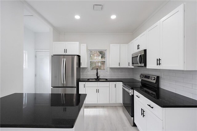 1097 Hubbard St SW, Atlanta, GA 30310 - kitchen with white cabinets, stainless steel appliances, ornamental molding, and sink