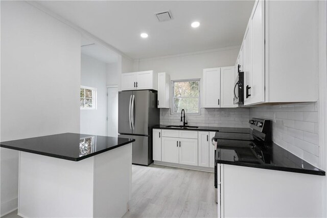 1097 Hubbard St SW, Atlanta, GA 30310 - kitchen with backsplash, sink, white cabinets, and stainless steel appliances