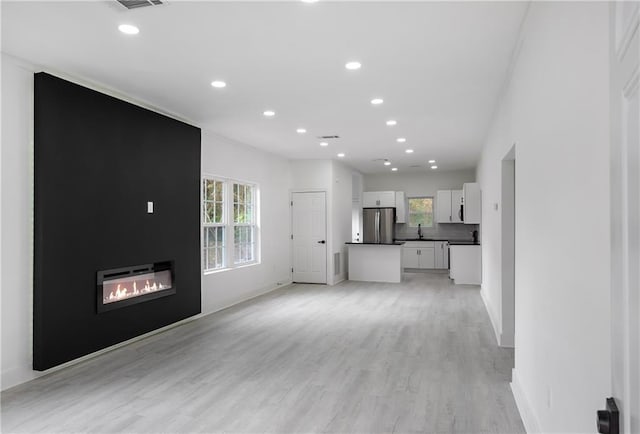1097 Hubbard St SW, Atlanta, GA 30310 - unfurnished living room with sink and light hardwood / wood-style floors