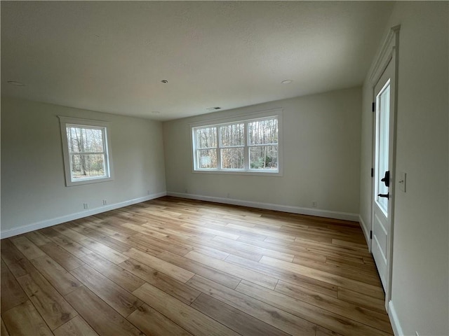 446 Brown Bridge Rd, Chatsworth, GA 30705 - spare room with healthy amount of natural light, wood finished floors, and baseboards