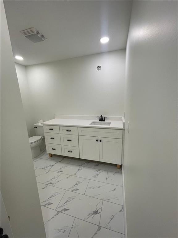 446 Brown Bridge Rd, Chatsworth, GA 30705 - bathroom with vanity, toilet, marble look tile flooring, and recessed lighting