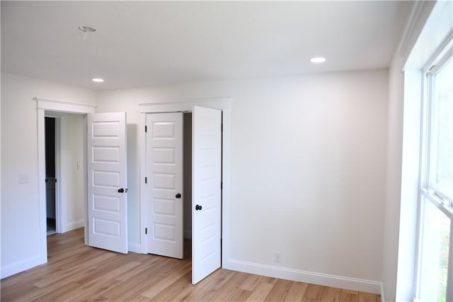 446 Brown Bridge Rd, Chatsworth, GA 30705 - unfurnished bedroom featuring light wood-style floors, recessed lighting, baseboards, and multiple windows