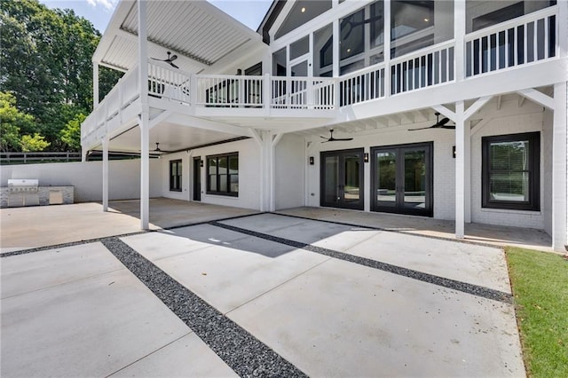 5651 Old Wilkie Rd, Gainesville, GA 30506 - rear view of house with ceiling fan, a patio area, a carport, brick siding, and a balcony