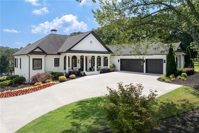 5651 Old Wilkie Rd, Gainesville, GA 30506 - view of front of property featuring concrete driveway, covered porch, an attached garage, stucco siding, and a chimney