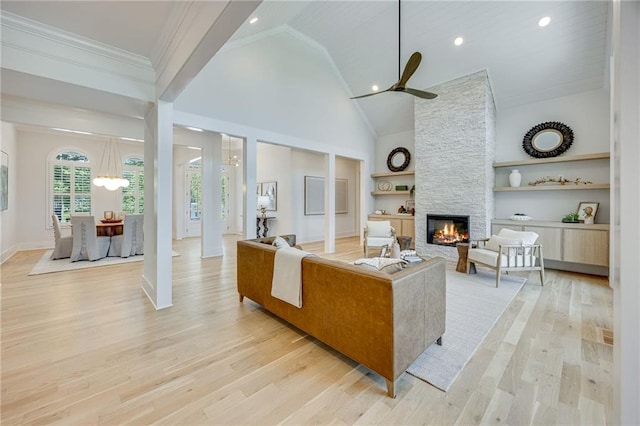 5651 Old Wilkie Rd, Gainesville, GA 30506 - living area with a stone fireplace, built in shelves, a ceiling fan, high vaulted ceiling, and light wood-style flooring