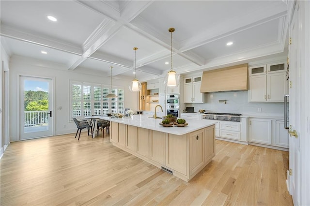 5651 Old Wilkie Rd, Gainesville, GA 30506 - kitchen featuring premium range hood, stainless steel appliances, light wood-style flooring, beam ceiling, and a large island with sink