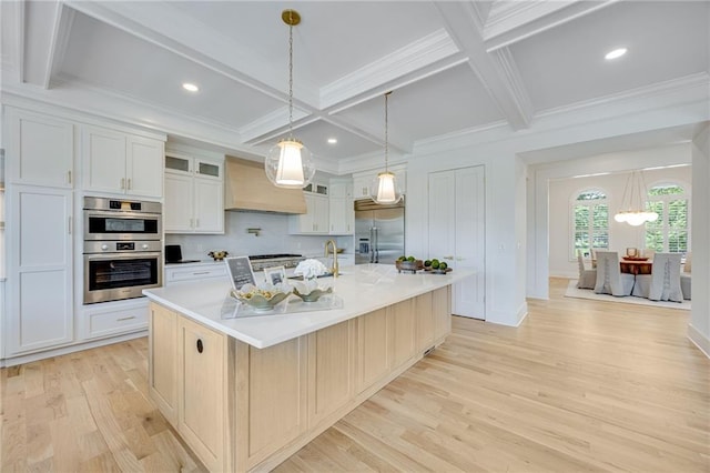 5651 Old Wilkie Rd, Gainesville, GA 30506 - kitchen with appliances with stainless steel finishes, custom range hood, coffered ceiling, light wood-type flooring, and a large island with sink