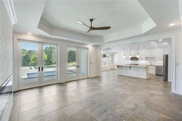 5651 Old Wilkie Rd, Gainesville, GA 30506 - unfurnished living room featuring a raised ceiling, plenty of natural light, a ceiling fan, french doors, and ornamental molding