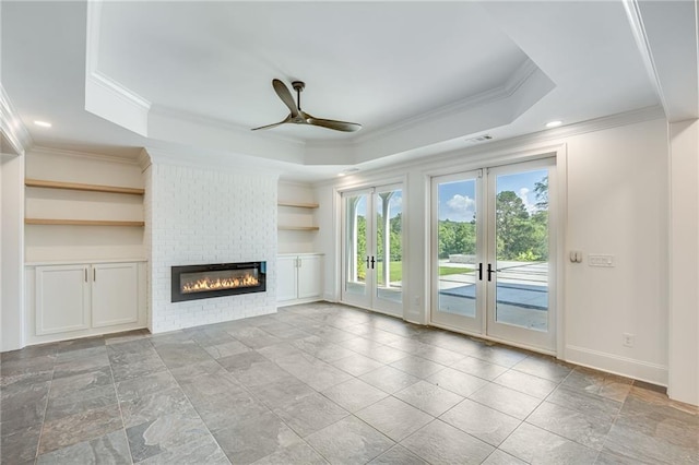 5651 Old Wilkie Rd, Gainesville, GA 30506 - unfurnished living room featuring a raised ceiling, ornamental molding, ceiling fan, a brick fireplace, and french doors