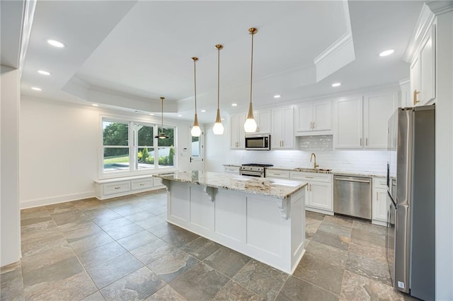 5651 Old Wilkie Rd, Gainesville, GA 30506 - kitchen featuring appliances with stainless steel finishes, a raised ceiling, crown molding, stone tile flooring, and recessed lighting