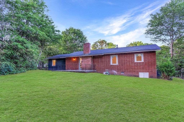 1091 Pine St, Conyers, GA 30012 - back of property with a chimney, a lawn, and brick siding