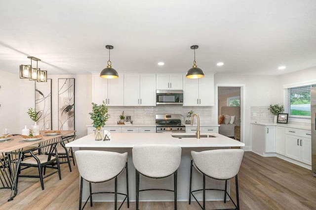 1091 Pine St, Conyers, GA 30012 - kitchen featuring stainless steel appliances, light countertops, tasteful backsplash, white cabinetry, and recessed lighting